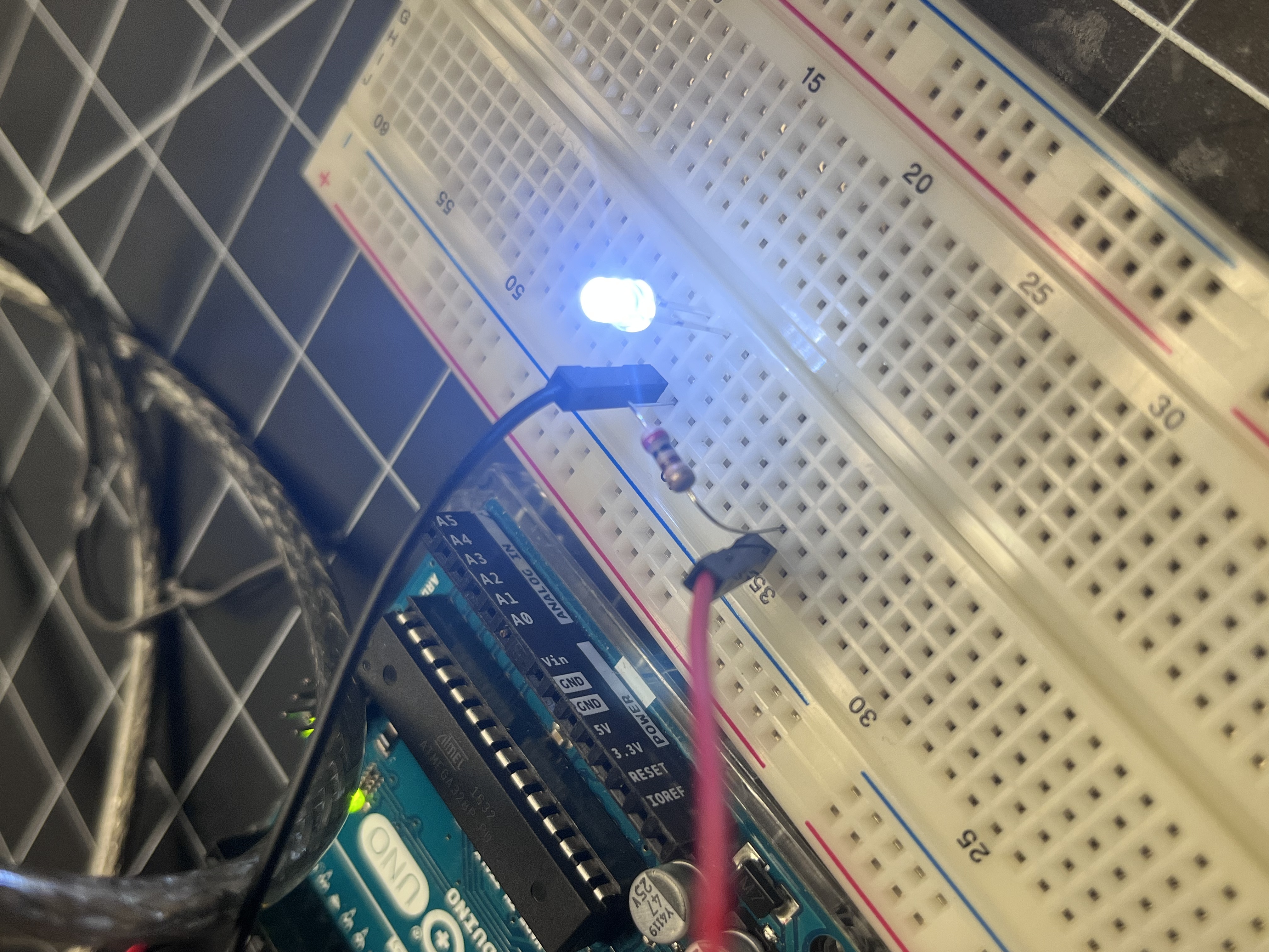 The LED lights up after uploading a basic “Blink” sketch through the Arduino IDE. The LED turned on and off in rhythm, proving successful communication between code and circuit. <div class='container'><iframe class='responsive-iframe' src='https://www.youtube.com/embed/tgbNymZ7vqY'></iframe></div>