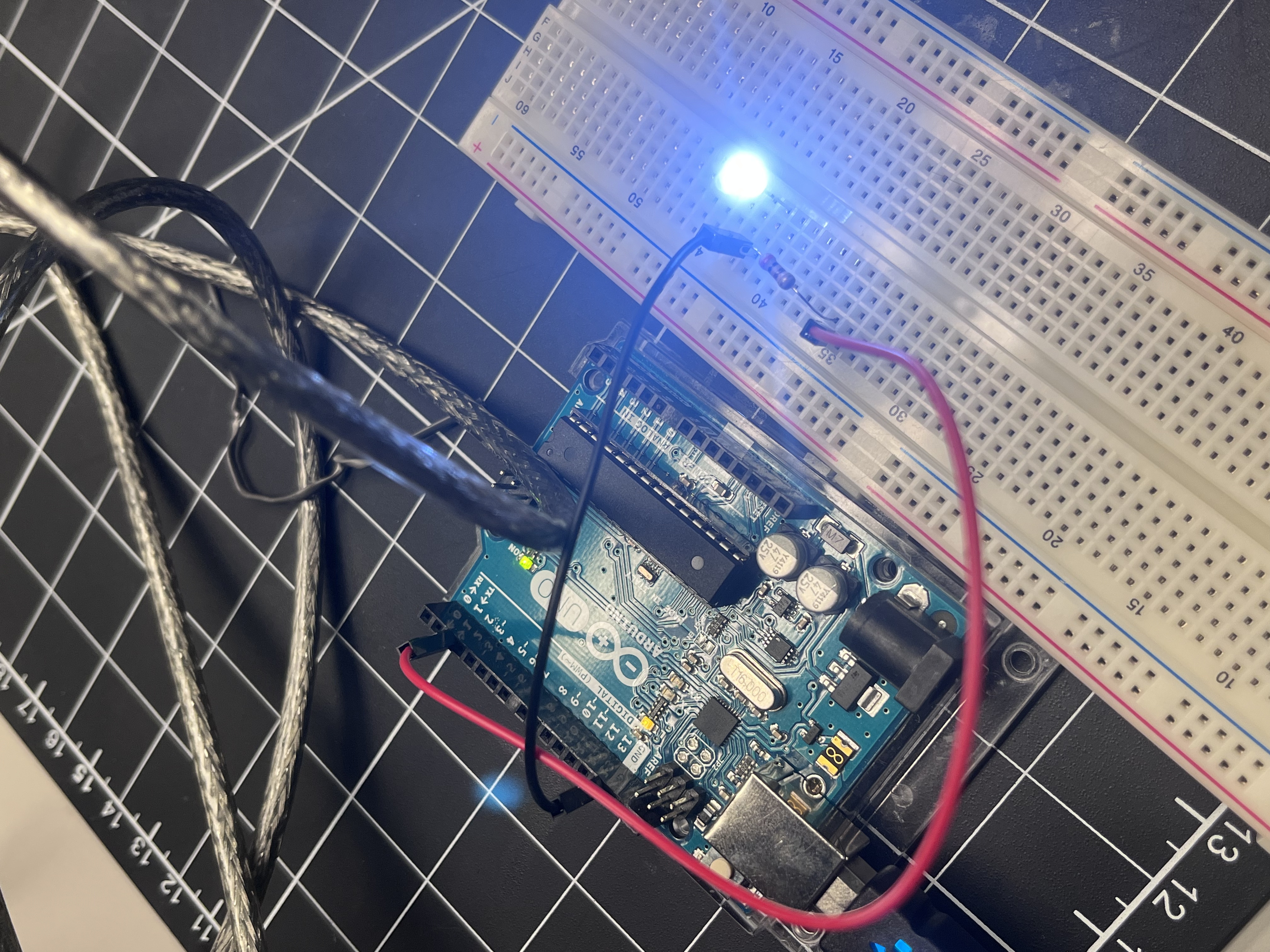 Adjustments were made to shorten jumper wires and secure the resistor connection for a cleaner layout. After re-arranging the components, the LED emitted steady light with no irregular flashes.