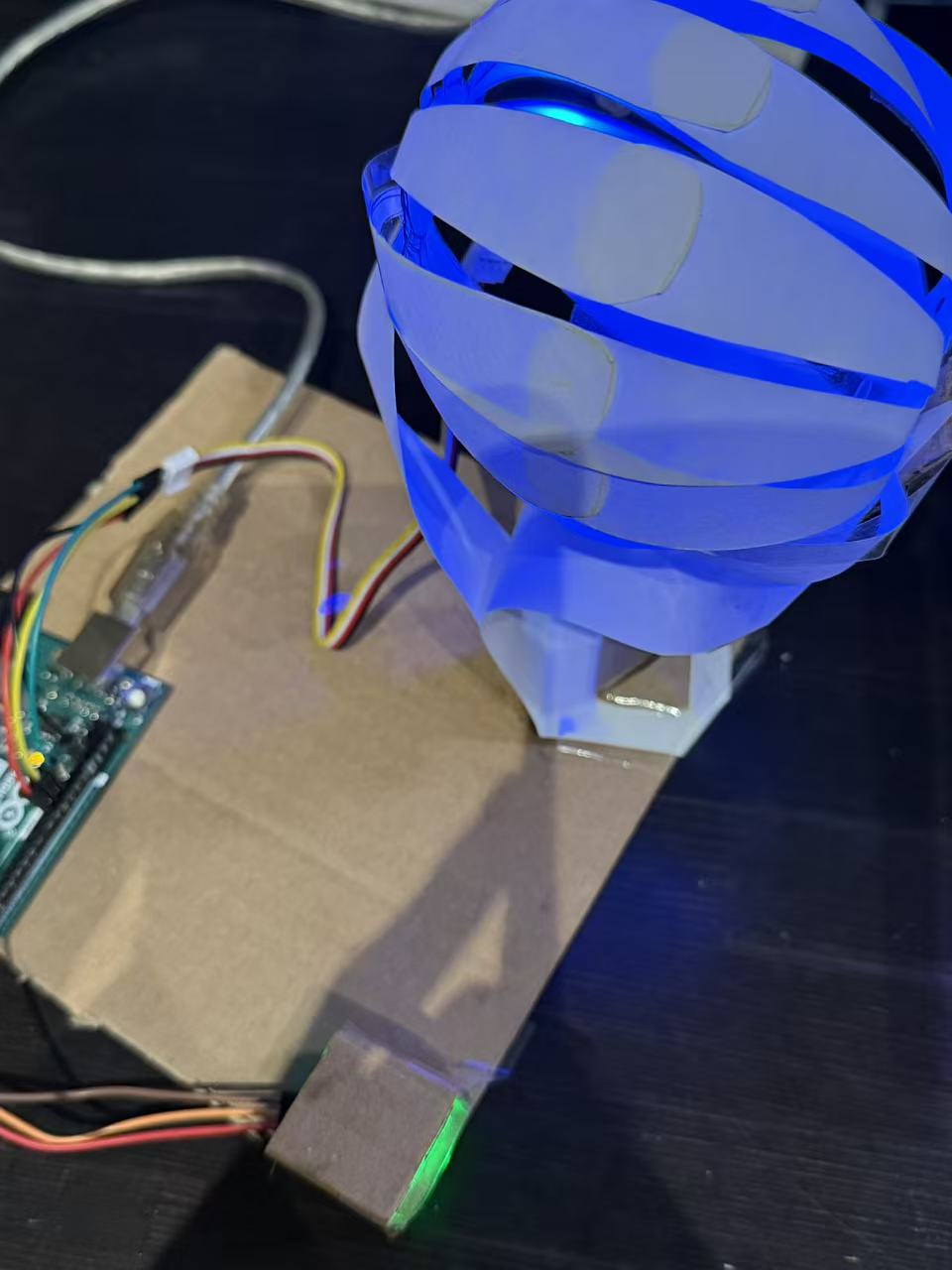 We built a rotating paper-sphere form using servo motion to explore dynamic, expressive movement in physical prototyping.